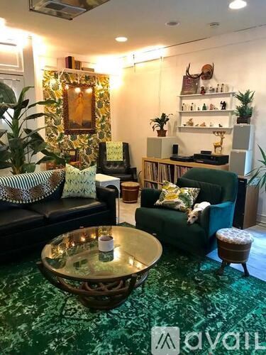 A living room with a green couch and a coffee table.