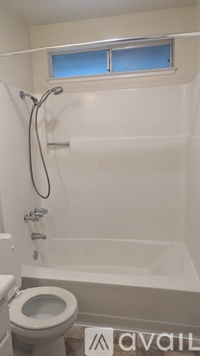 A white bathroom with a toilet and a bathtub.