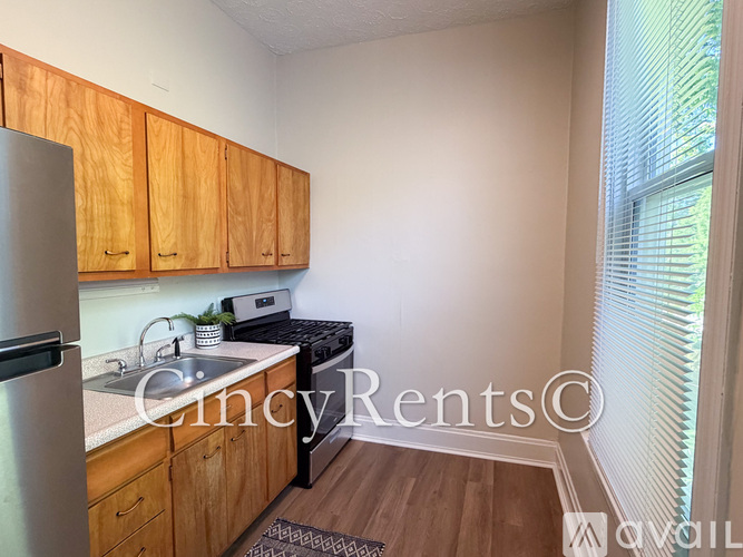 A kitchen with wooden cabinets and a refrigerator.
