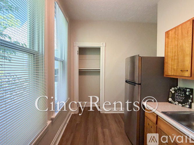 A kitchen with wooden cabinets and a refrigerator.
