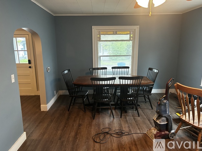 A dining room with a table and chairs.