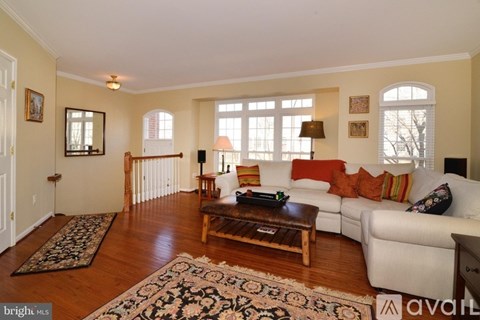 A living room with a white couch and a coffee table.