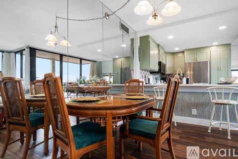 A dining room with a wooden table and chairs.