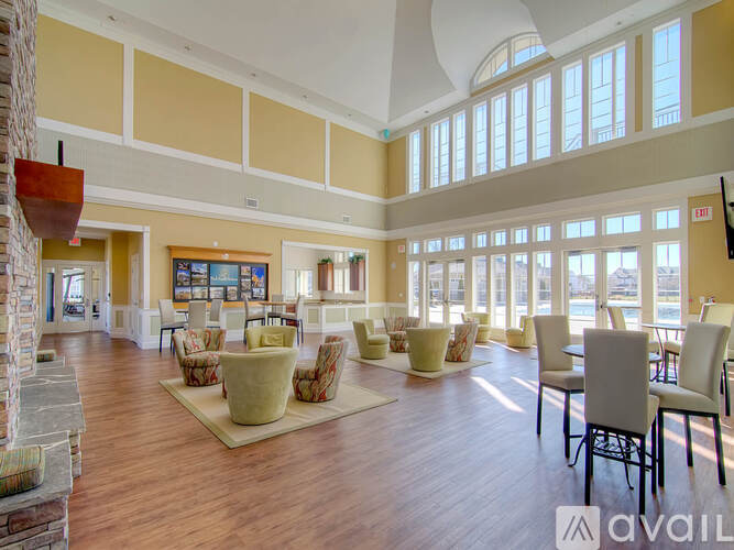 A spacious room with wooden floors and a large window.