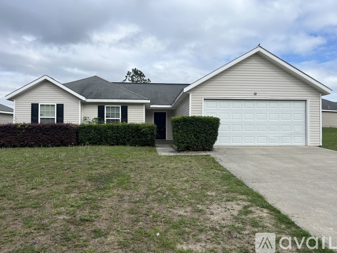 A house with a grey roof and a white garage door.