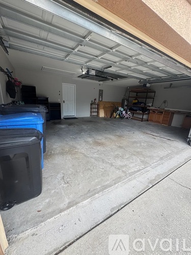 A spacious garage with a blue toolbox and a bicycle.