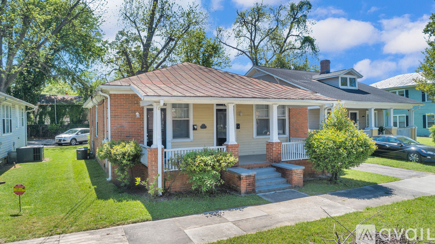 A house with a red roof and a front porch.