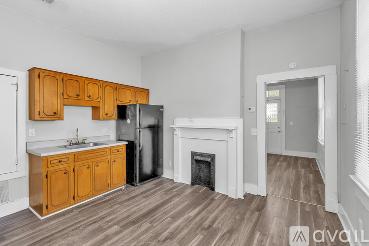 A kitchen with wooden cabinets and a refrigerator.