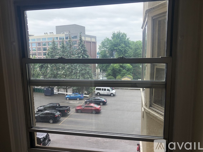 A view of a parking lot from a window.