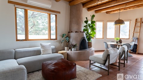 A living room with a grey couch, a brown bean bag chair, and a wooden coffee table.