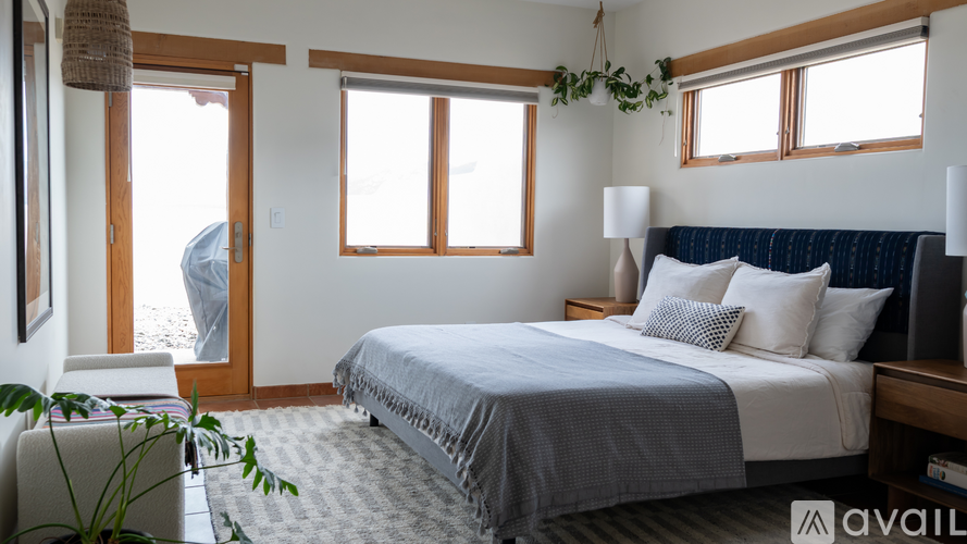 A bedroom with a large bed and a window.