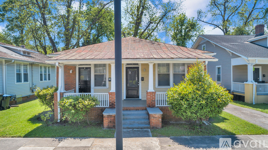 A house with a red roof and a front porch.