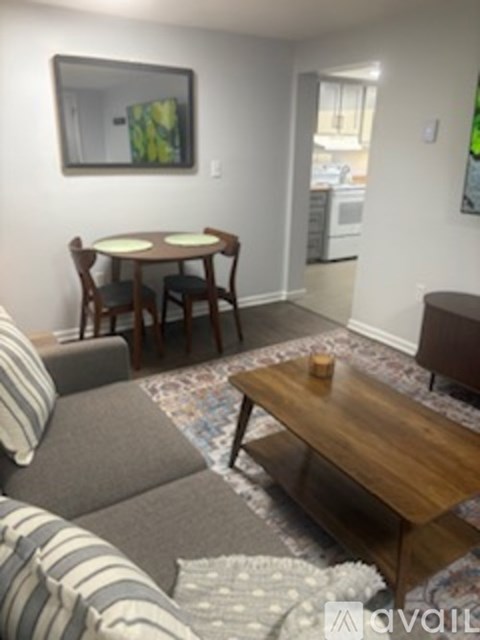 A living room with a grey couch and a wooden coffee table.