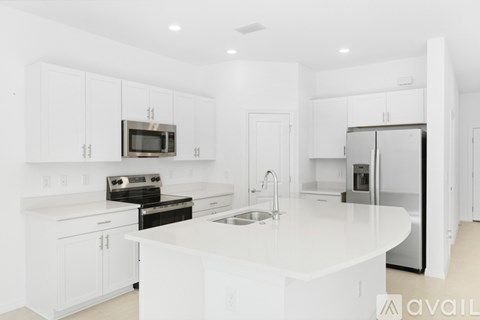 A kitchen with white cabinets and appliances.
