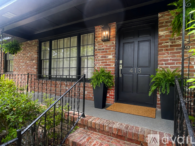 A black door with a number 413 on it.