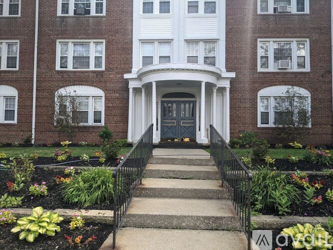 A brick building with a white door and steps leading up to it.