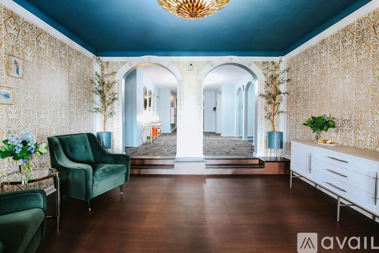 A room with a green chair and a wooden floor.