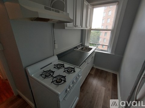 A small kitchen with a stove and a window.
