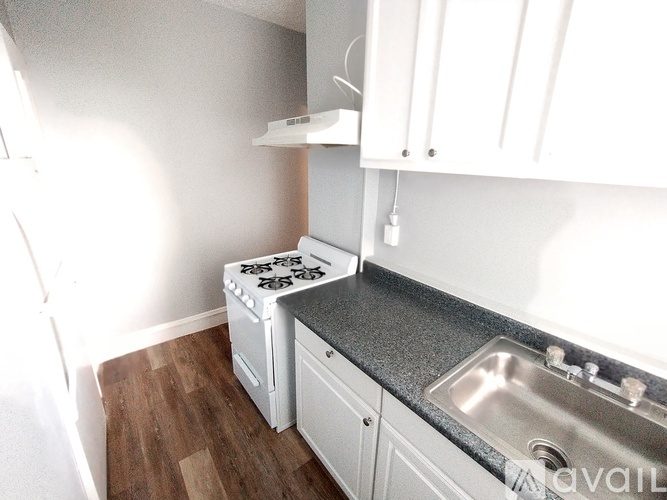 A small kitchen with a stove and sink.