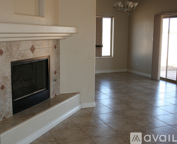A living room with a fireplace and tiled flooring.