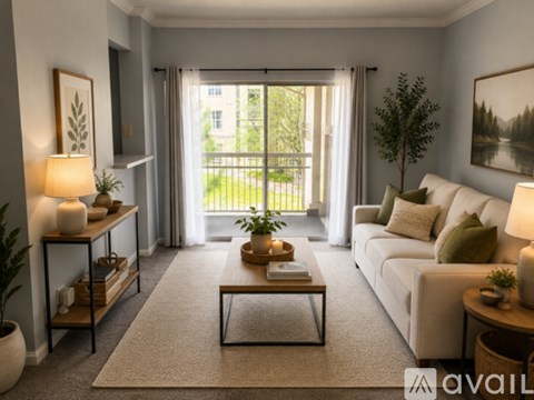 A well-lit living room with a large window and a white sofa.