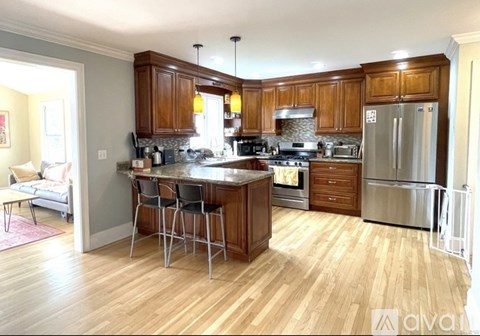 A kitchen with wooden cabinets and a center island.