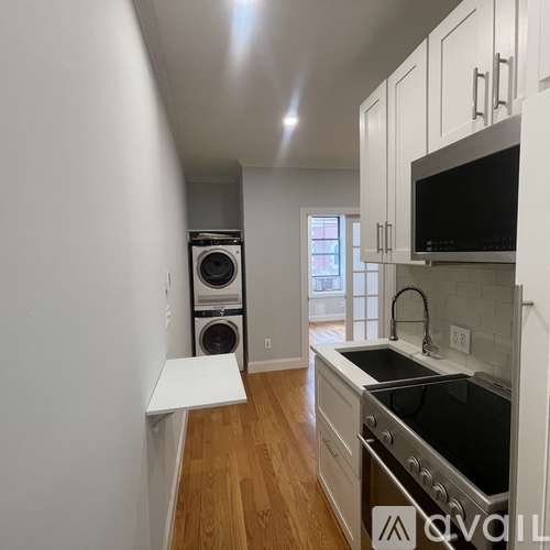 A kitchen with a white countertop and stainless steel appliances.