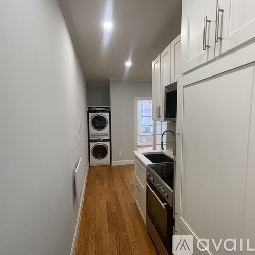 A kitchen with white cabinets and a stainless steel dishwasher.
