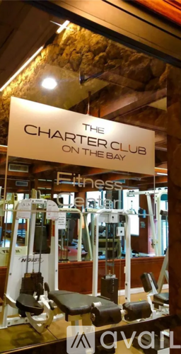 A gym with a sign that says The Charter Club on the Bay.
