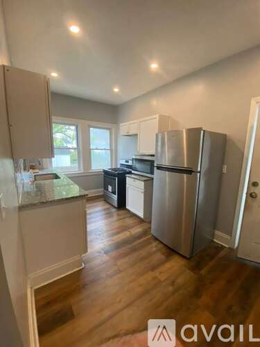 A kitchen with wooden floors and stainless steel appliances.