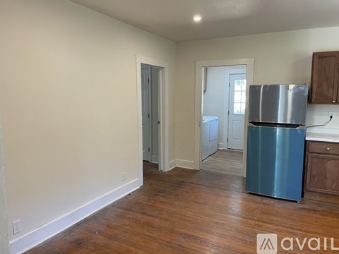 A kitchen with a blue refrigerator and wooden cabinets.
