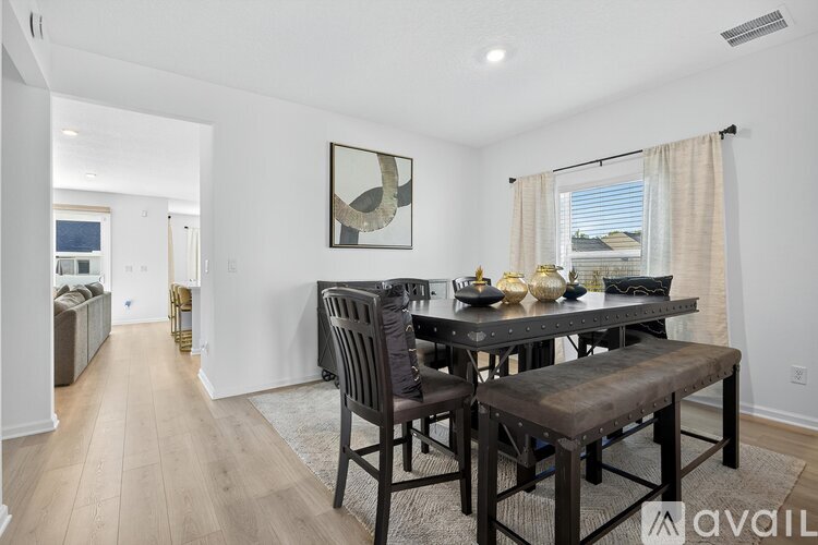 A dining room with a wooden table and chairs.
