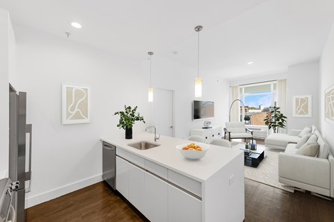 A modern kitchen with white cabinets and a large island.
