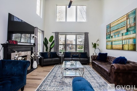 A living room with a fireplace and a painting on the wall.