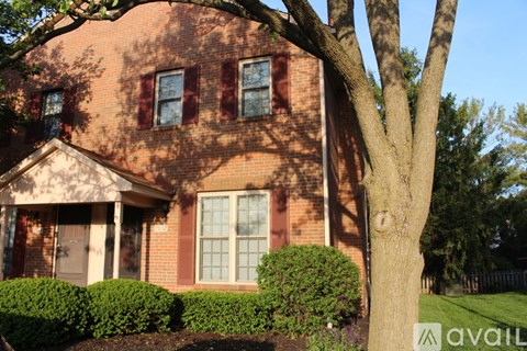 A house with a tree in front of it.