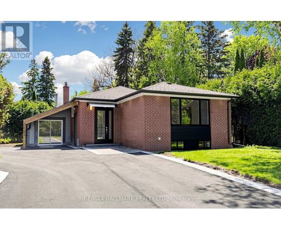 A modern house with a brick exterior and a large driveway.