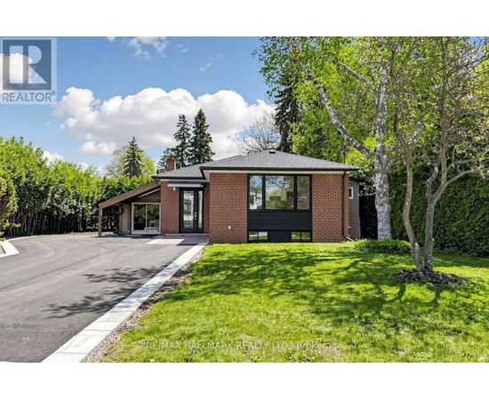 A house with a brick facade and a large front yard.