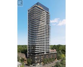 A tall building with many windows and balconies is surrounded by trees.