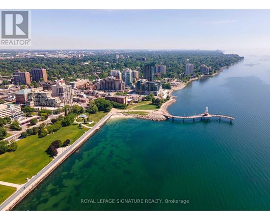 A cityscape with a body of water and a pier.