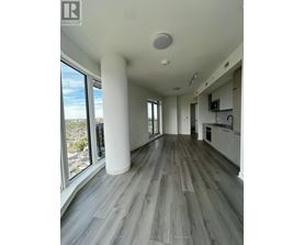 A spacious room with a large window overlooking a cityscape.