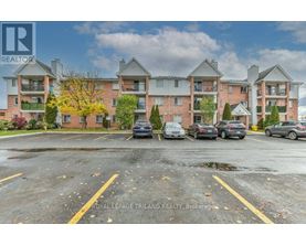 A parking lot in front of a multi-story apartment building.