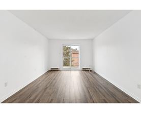A room with wooden floors and white walls.