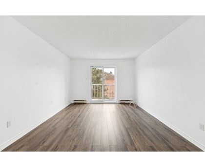 A room with wooden floors and white walls.