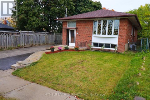 A red brick house with a white door and windows.