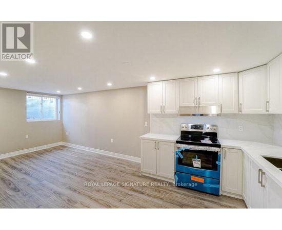 A kitchen with a blue oven and white cabinets.
