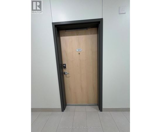 A door with a number 101 on it is in a hallway.