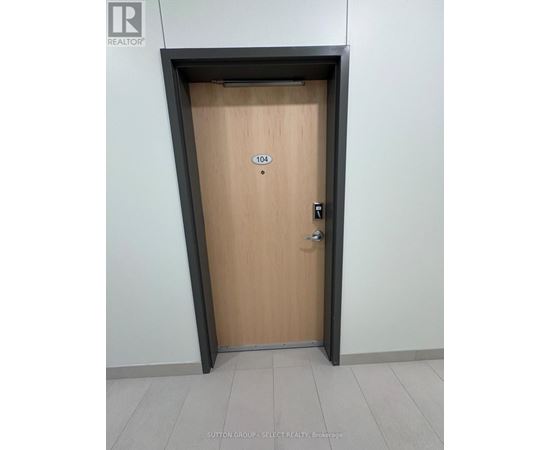 A wooden door with a number 104 on it.