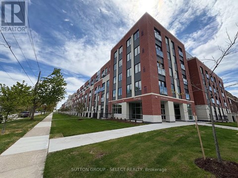 A large red brick building with a walkway in front of it.