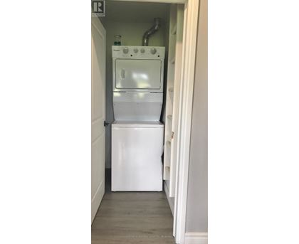 A white dishwasher is installed in a narrow kitchen space.