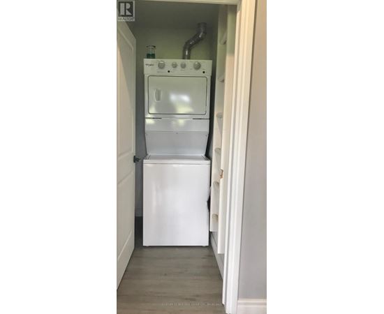 A white dishwasher is installed in a narrow kitchen space.